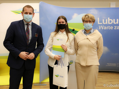 Marszałek Elżbieta Anna Polak oraz wicemarszałek Łukasz Porycki na pamiątkowym zdjęciu ze studentkom, która otrzymała stypendium motywujące