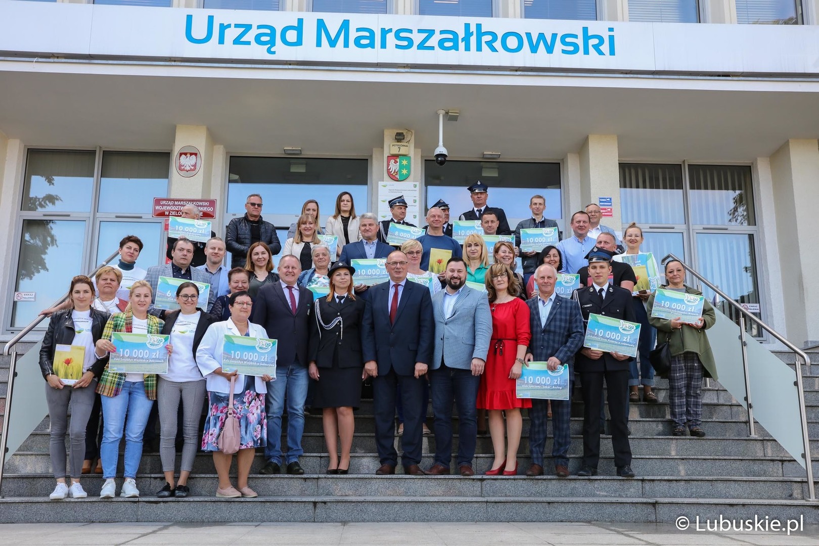 1 czerwca 2022 r. wicemarszałek Stanisław Tomczyszyn podpisał umowy z beneficjentami V edycji Lubuskiej Odnowy Wsi. Zdjęcie uczestników spotkania na schodach Urzędu Marszałkowskiego Województwa Lubuskiego 
