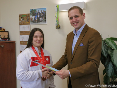 Wicemarszałek Województwa Lubuskiego Łukasz Porycki składa gratulacje zawodniczce Klubu Karate Kontra w Żarach Martynie Grajcar
